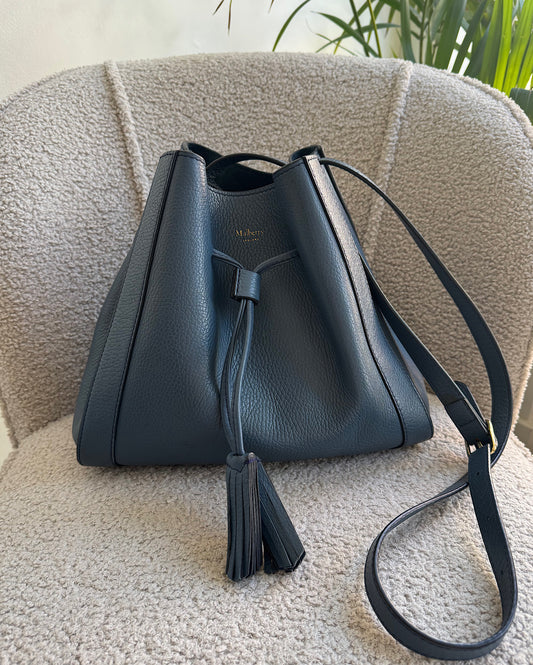 A navy Mulberry small Millie bucket bag with a long adjustable strap and a detachable small zipped purse, displayed on a neutral background.