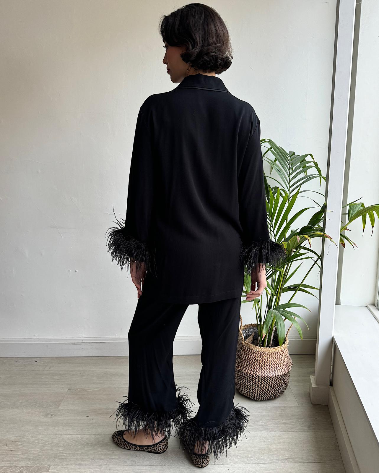 Back view of of bestselling black party pyjamas from SLEEPER with ostrich feather trim