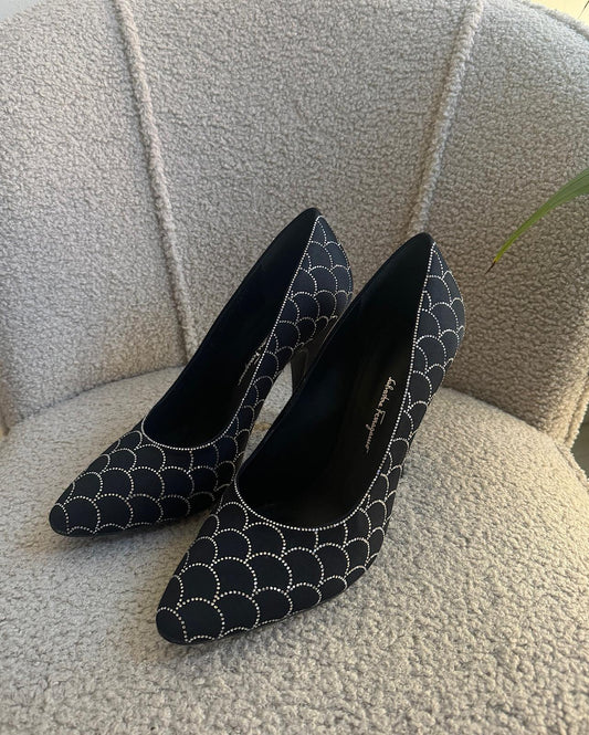 Front view of stunning pair of black satin heels by Salvatore Ferragamo. Semi pointed with crystal embellishments.