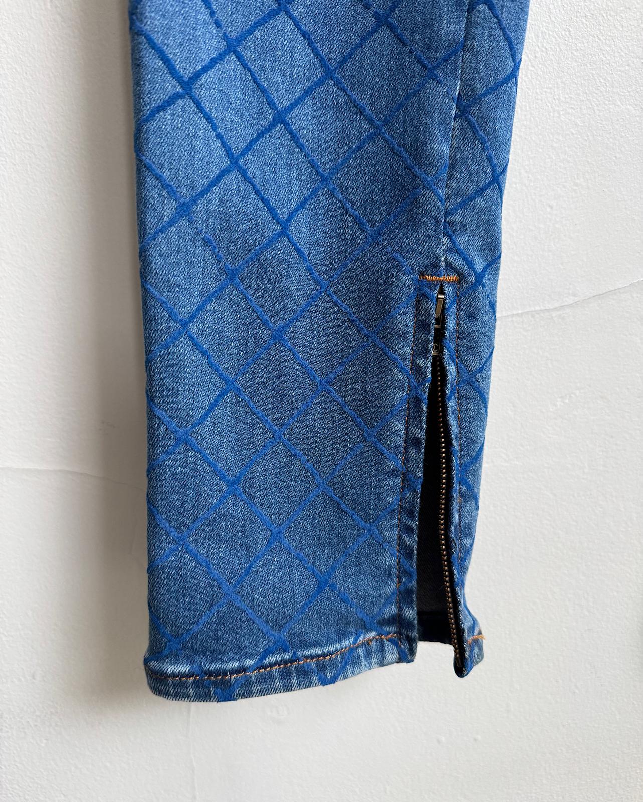 ankle zipper detail of stunning pair of blue slim-fit denim jeans by Chanel, featuring an all-over textured pattern