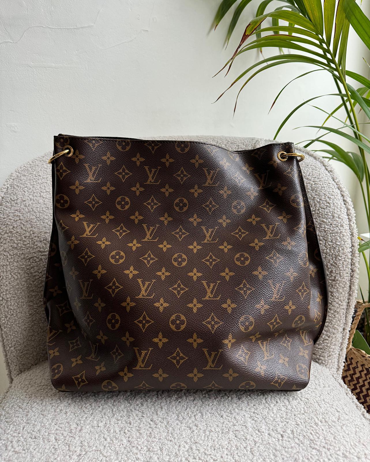 Back view of beautiful Methis Hobo tote by Louis Vuitton showcases the iconic LV monogram