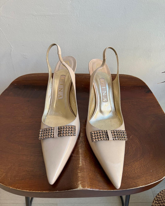 Front view of beautiful pair of cream slingbacks by Gina, featuring pale pink diamanté bows.