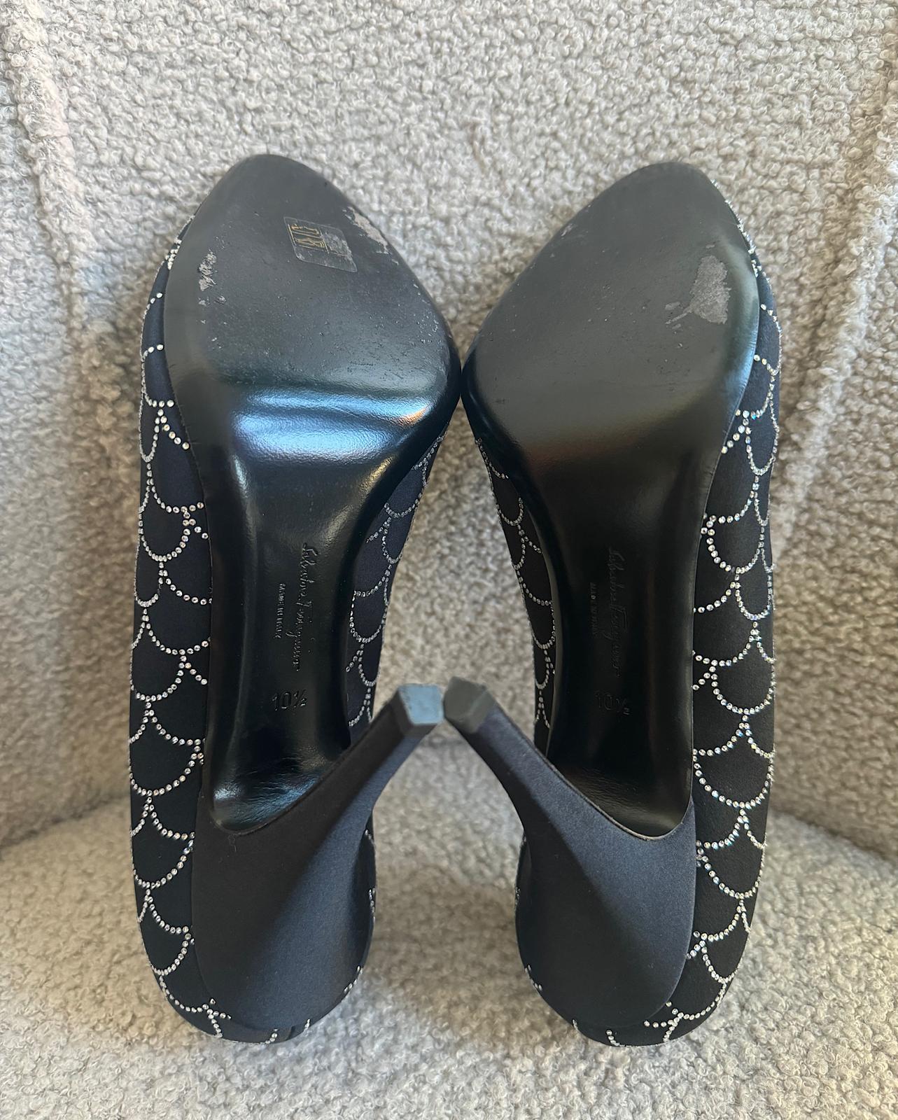 soles of stunning pair of black satin heels by&nbsp;Salvatore Ferragamo. Semi pointed with crystal embellishments.