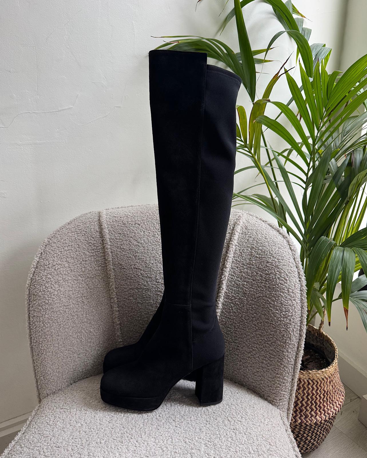 Side view of fashionable pair of black over-the-knee 'Honey Hi' platform boots from Russell &amp; Bromley