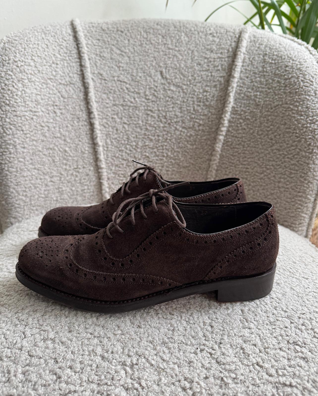 Side view of stylish pair of brown suede wingtip Oxford shoes from Moloh