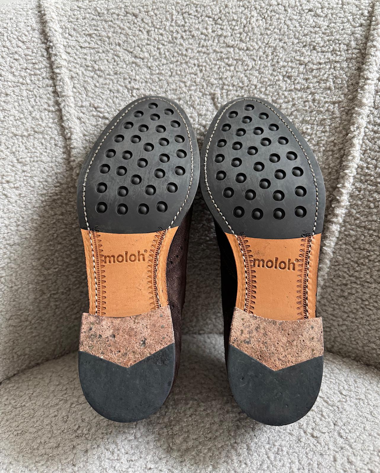 Soles of stylish pair of brown suede wingtip Oxford shoes from Moloh. Only worn twice.