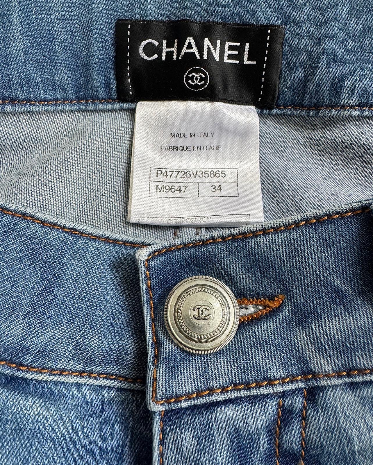 Label and buttons of gorgeous pair of blue-wash denim skinny jeans from Chanel