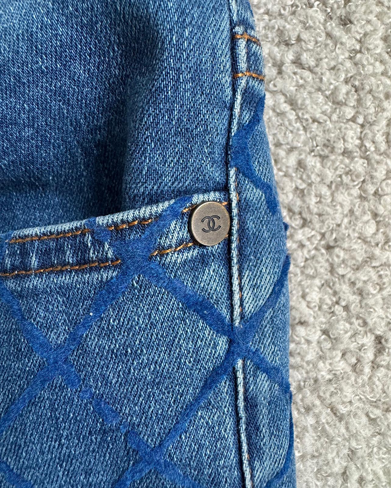 Close up of stunning pair of blue slim-fit denim jeans by Chanel, featuring an all-over textured pattern and ankle zippers