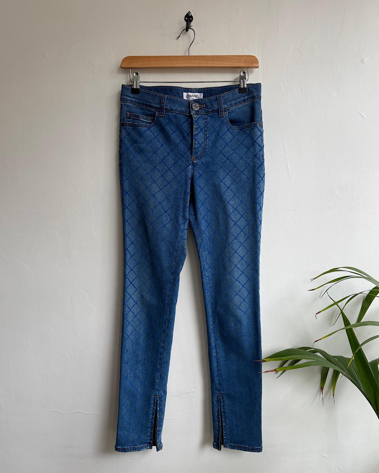 Full view of stunning pair of blue slim-fit denim jeans by Chanel, featuring an all-over textured pattern and ankle zippers