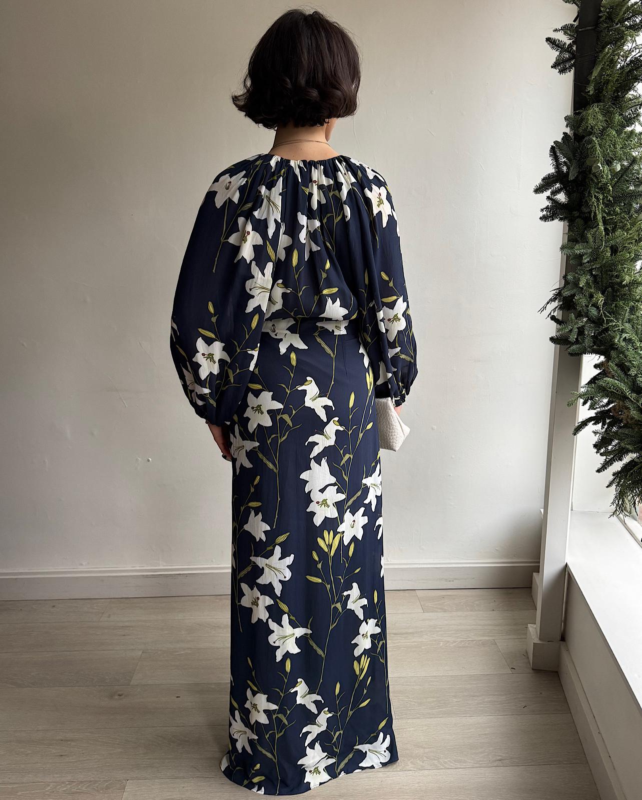 Back view of The 'Evian' maxi dress, designed by Bernadette, showcases a stunning navy lily print.