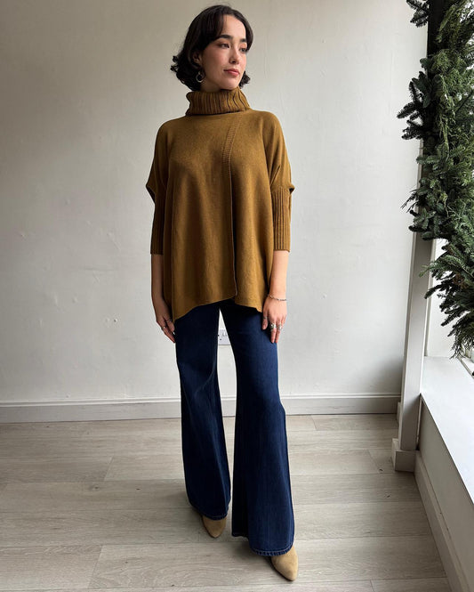 Front view of stunning mustard cashmere-blend roll-neck knit by Diane Von Furstenberg features both front and back splits