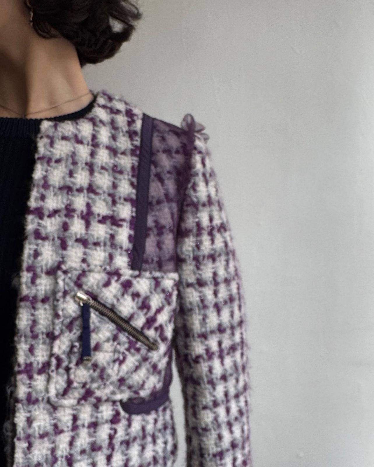 Close up of stylish short tweed jacket by Luella is fully lined in silk and features beautiful tulle details.