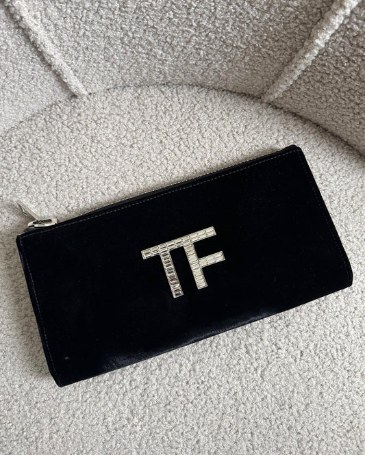 Front view of stunning black velvet clutch by Tom Ford showcases a beaded crystal 'TF' logo on the front and features a zip-top closure.