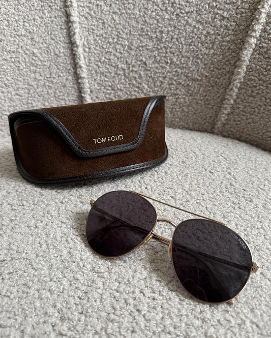 Tom Ford aviator-style sunglasses. They feature gold frames with grey lenses.